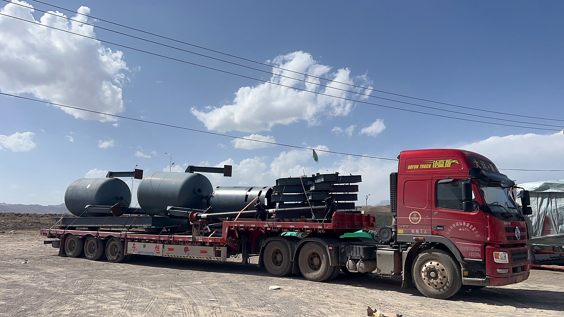 Industrial cargo secured on a red flatbed truck